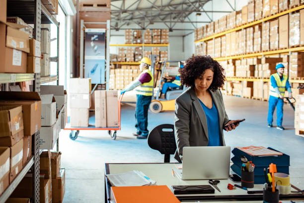 Close up of a warehouse manager using a laptop