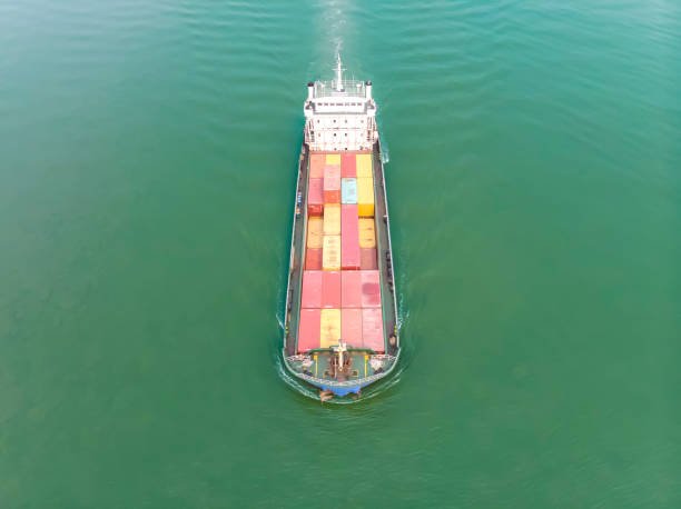 Aerial view, Small container ships loaded container are running in the river, business of transportation, import and export by container ship.