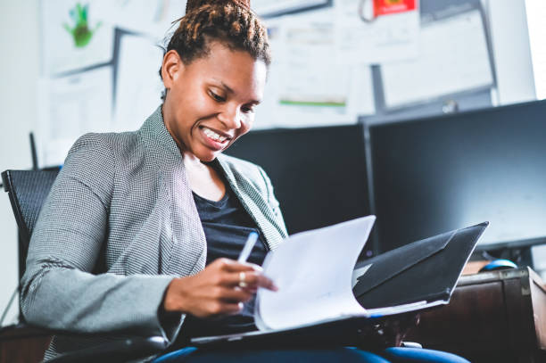 Woman looks through documents with face of concern. Common business mistakes to avoid