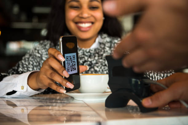 Using a pay by phone scanner to buy a coffee at a cafe